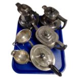 A three piece plated tea service together with three further plated tea and coffee pots.
