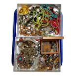 Two boxes containing a large quantity of assorted costume jewellery including silver rings.