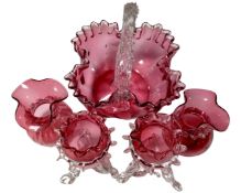 An antique cranberry glass basket together with two pairs of vases.