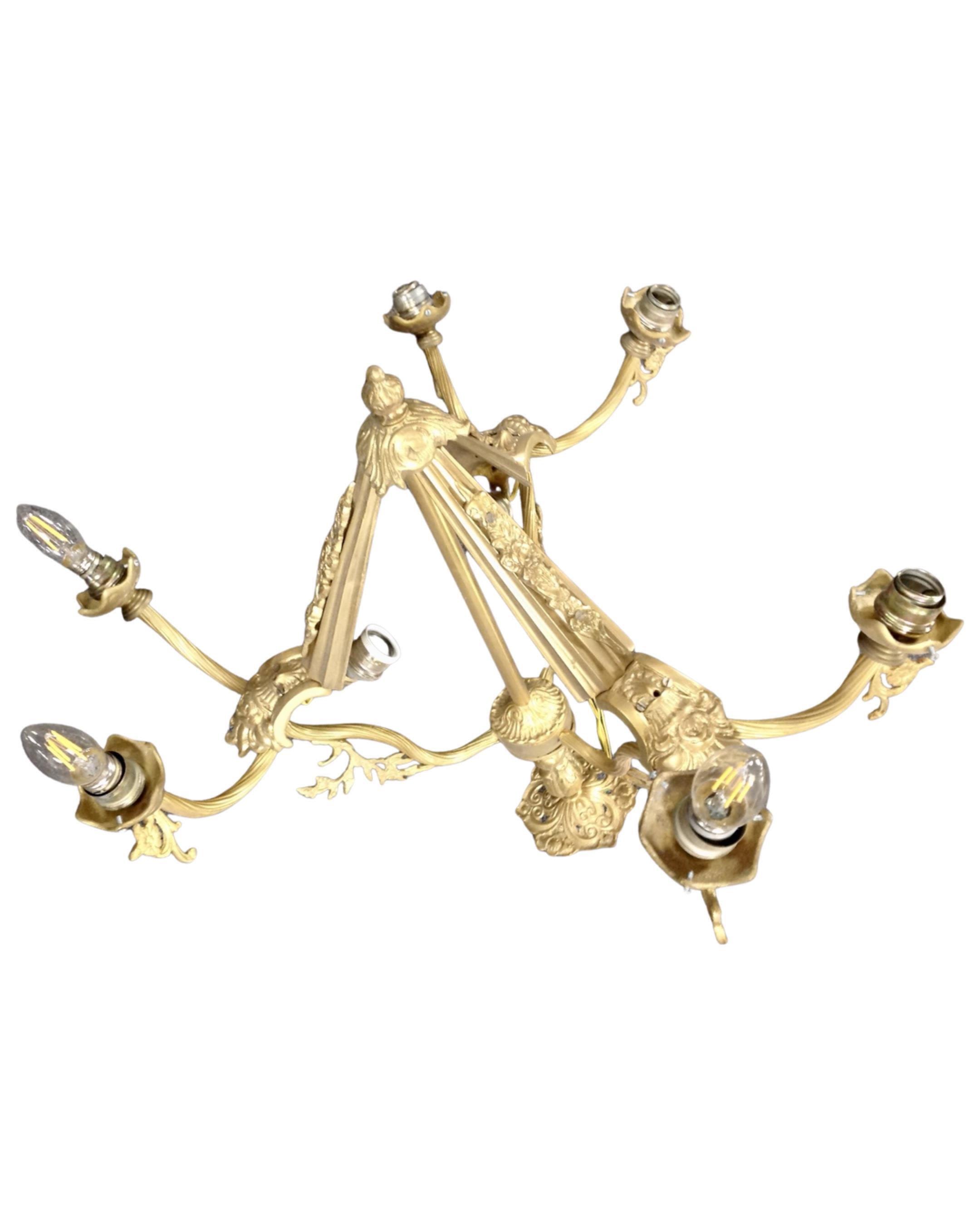 An antique gilt metal nine-way light fitting