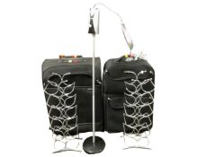 Two luggage cases together with two metal wine racks and a battery operated angle poise lamp.