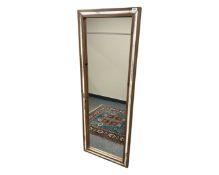 A pine framed mirror, 56cm by 150cm.