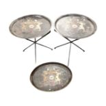 A pair of metal folding occasional tables bearing coat of arms together with matching serving tray