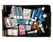A crate containing a large quantity of makeup remover and folding hairbrushes.