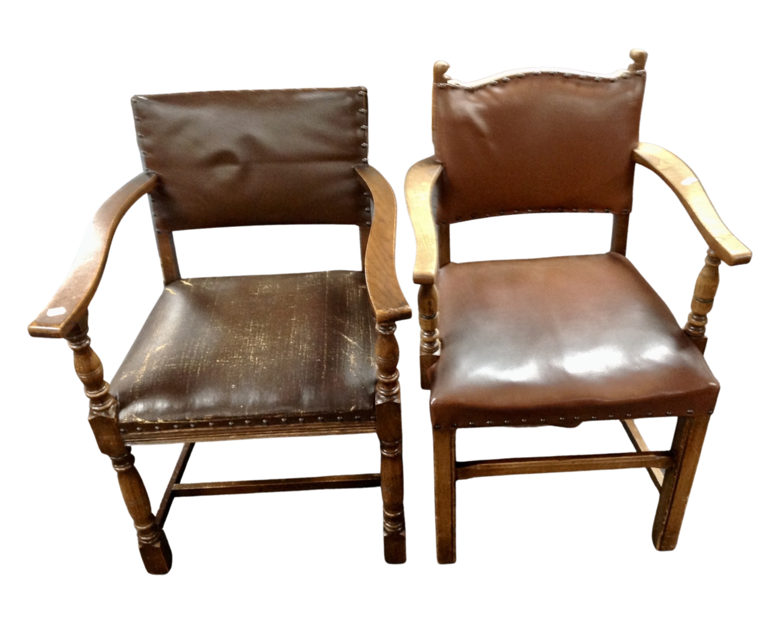 Two armchairs upholstered in brown studded leather