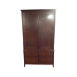 A Victorian style double door wardrobe fitted with four drawers
