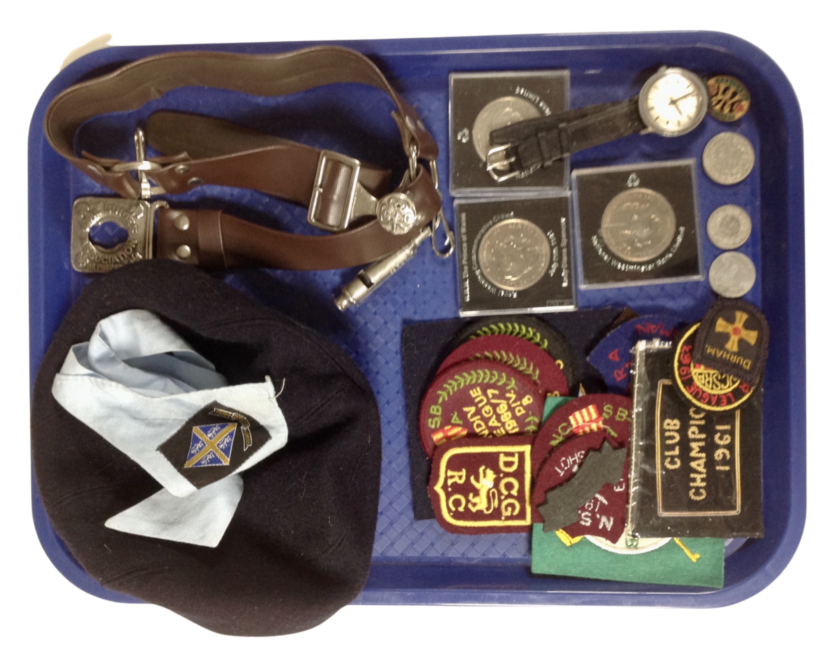 A tray containing commemorative crowns and coins, a gent's Timex wristwatch, girl guides,