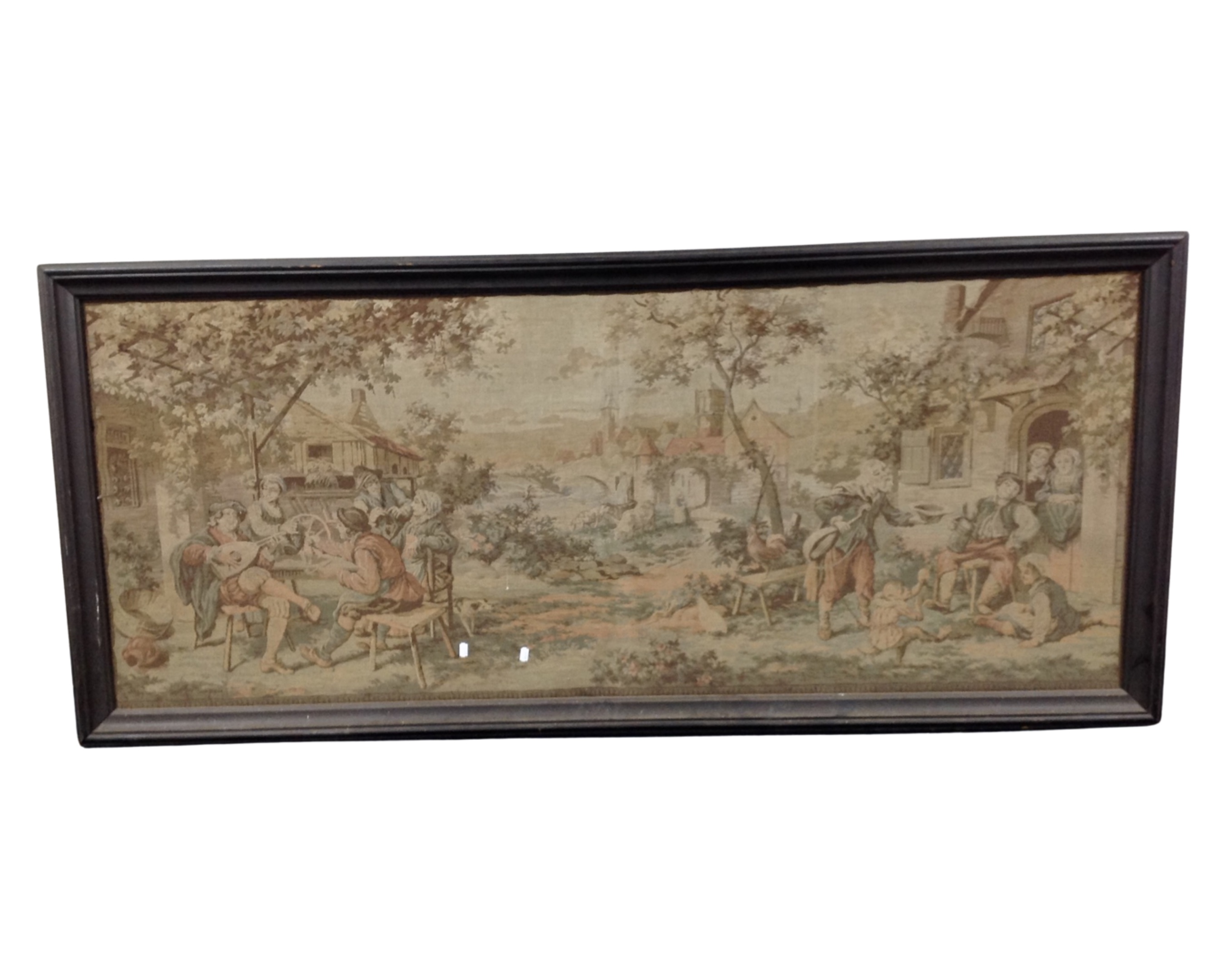 A large needlework panel depicting figures in rural village, framed.