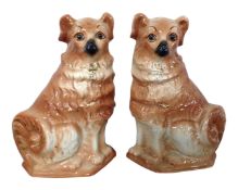 A pair of Staffordshire fireside dogs with glass eyes.