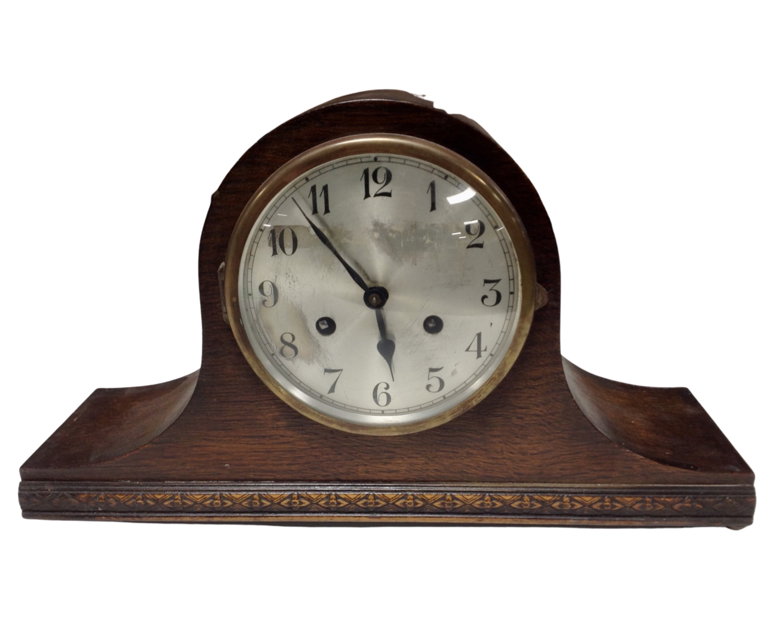 An oak cased eight day mantel clock with silvered dial.