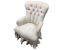 A Victorian style lady's chair in striped buttoned fabric