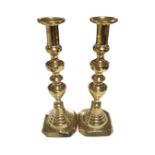 A pair of 19th century brass candlesticks (height 30.5cm).