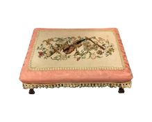 A large upholstered beech footstool, the tapestry top depicting a violin and sheet music,