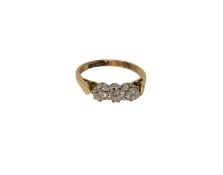 An 18ct gold three stone diamond ring, size K CONDITION REPORT: 2.