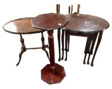 A nest of three mahogany tables together with a walnut occasional table and plant stand