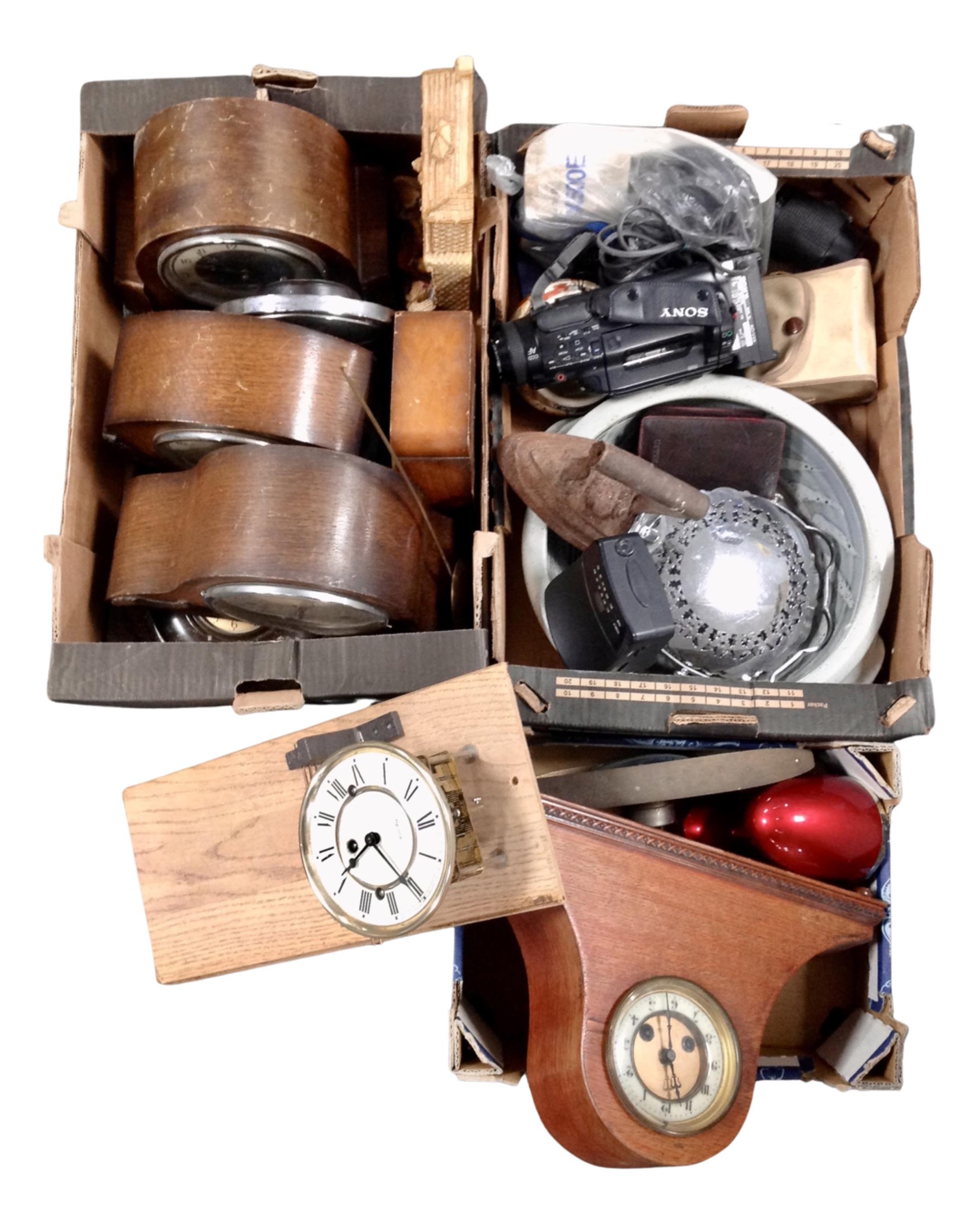 Three boxes containing assorted mantel and wall clocks, a pottery bowl, a cast flat iron,