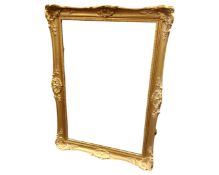 A gilt swept framed mirror