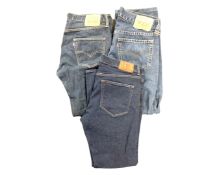 Two pairs of Levi Strauss jeans together with a further pair of Gant jeans.