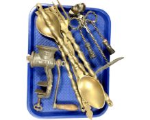 A set of oversized brass utensils with rack,