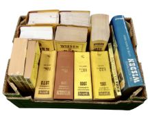 A box containing Wisden Cricketers Almanack and books.