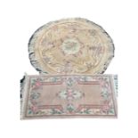 A circular fringed Chinese rug, diameter 136cm, together with a further rectangular Chinese rug,
