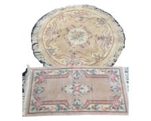 A circular fringed Chinese rug, diameter 136cm, together with a further rectangular Chinese rug,