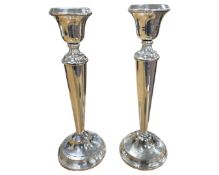 A pair of loaded silver candlesticks, marks rubbed, height 29.5cm.