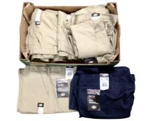 A box containing Dickies flat front work pants.