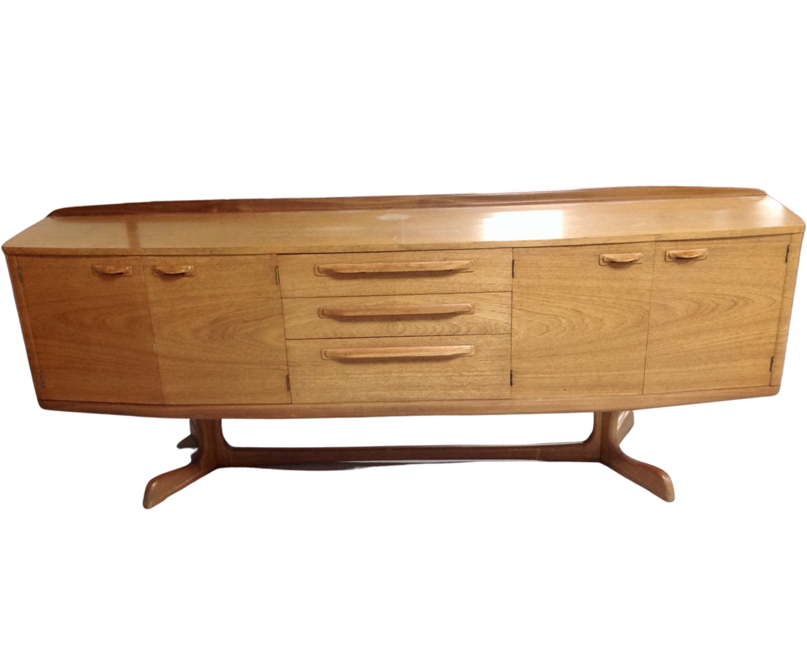 A 20th century Chapmans Siesta teak bow fronted teak four door sideboard fitted with three central