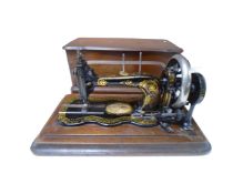 A 19th century Bradbury sewing machine in mahogany case.