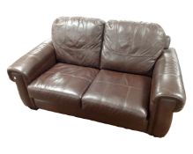 A brown leather two seater settee