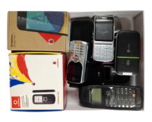 A box containing mobile phones including Nokia, Vodafone, Motorola, LG etc.