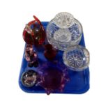 A tray containing assorted glassware including a crystal rose bowl, cranberry glass jug,