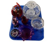 A tray containing assorted glassware including a crystal rose bowl, cranberry glass jug,