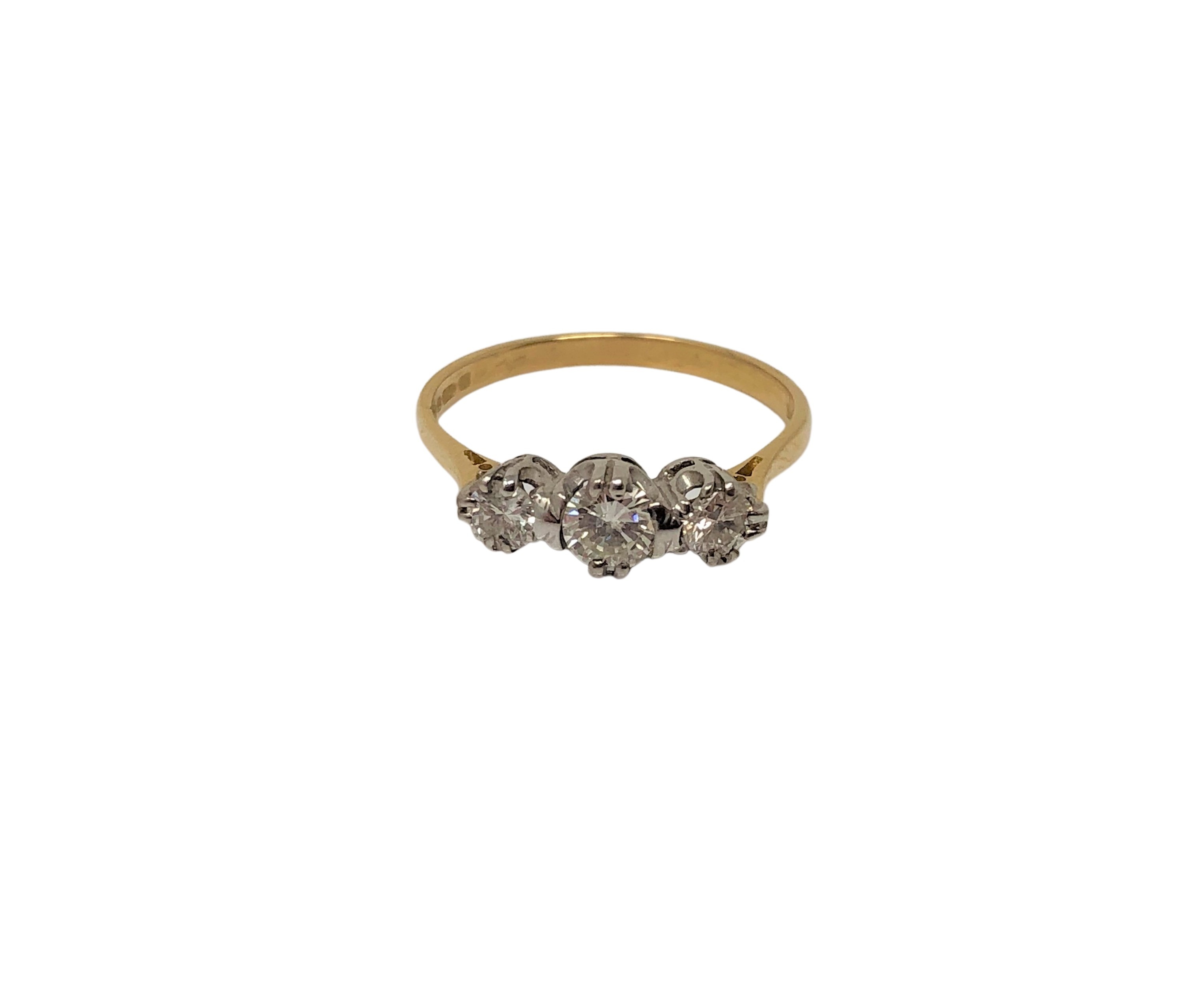 An 18ct gold three stone diamond ring, size N CONDITION REPORT: 2.