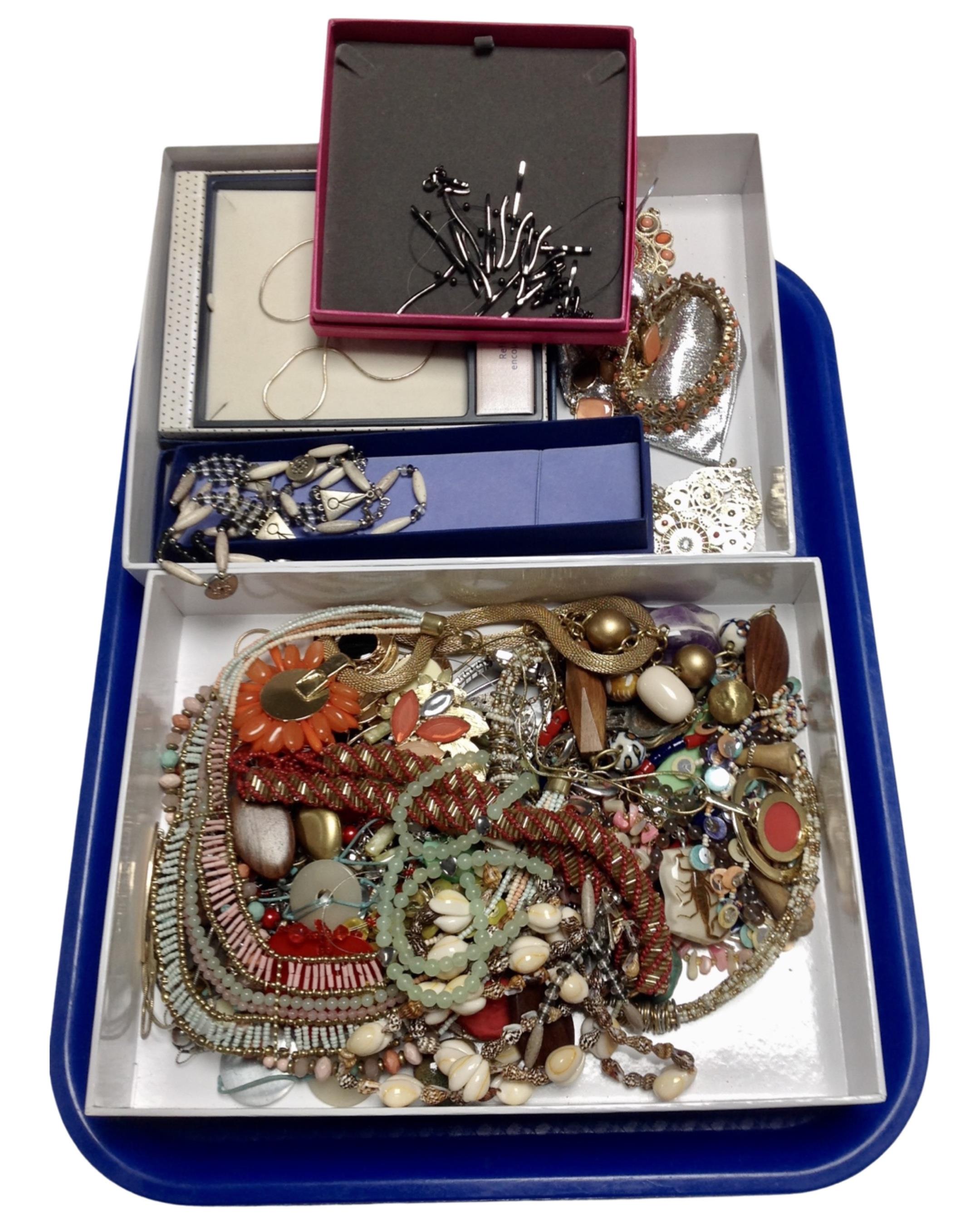 Two boxes containing a large quantity of assorted costume jewellery.