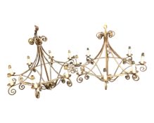 A pair of antique cast metal eight way pendant light fittings.