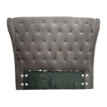 A 6' bed head upholstered in buttoned fabric