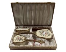 A four piece Regent dressing table brush set, in box.