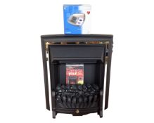 A Be Modern coal effect electric fire together with an Omron blood pressure monitor.