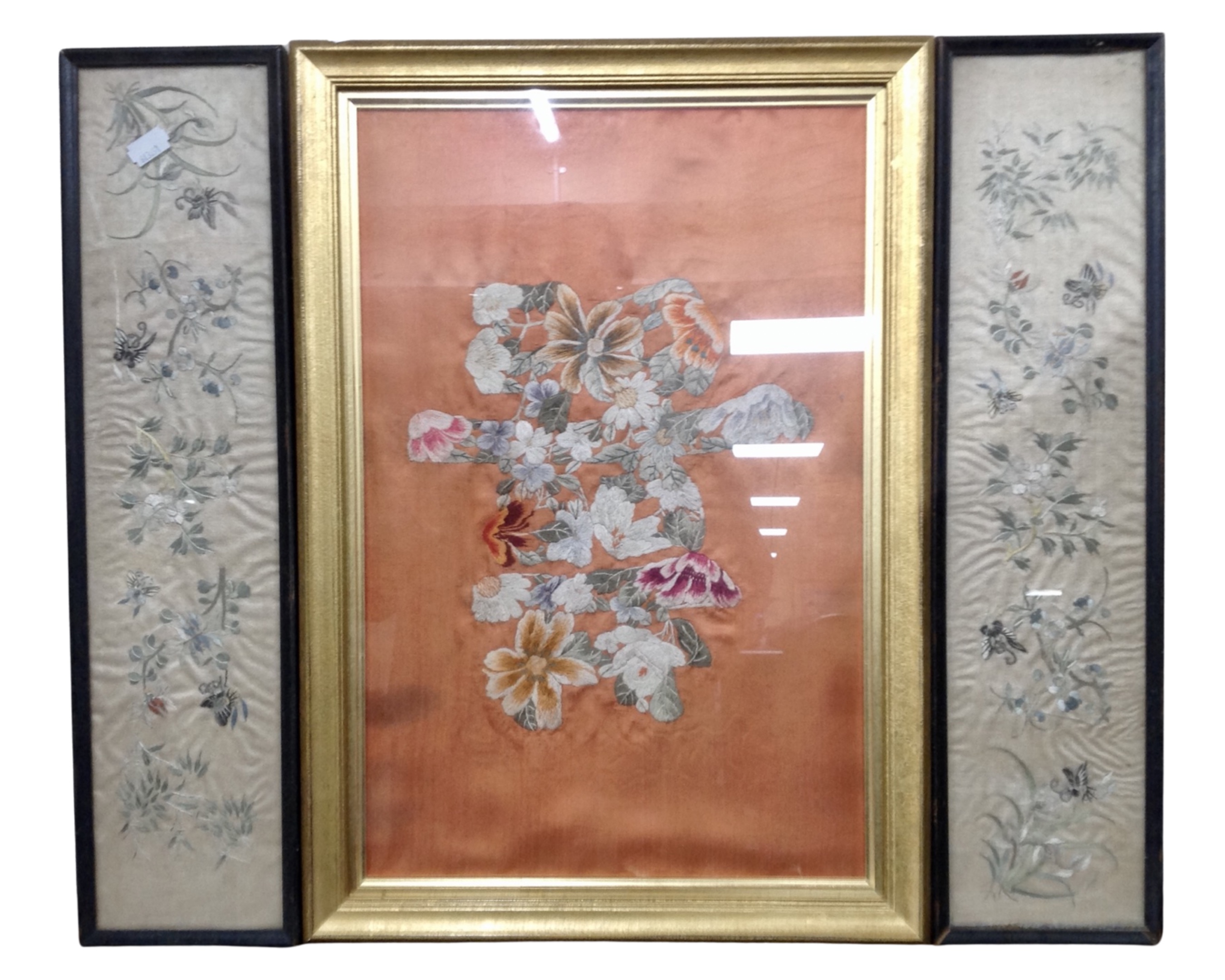 Three Chinese embroidered silk work panels, framed.