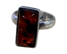 A sterling silver ring set with amber, size M.