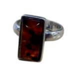 A sterling silver ring set with amber, size M.