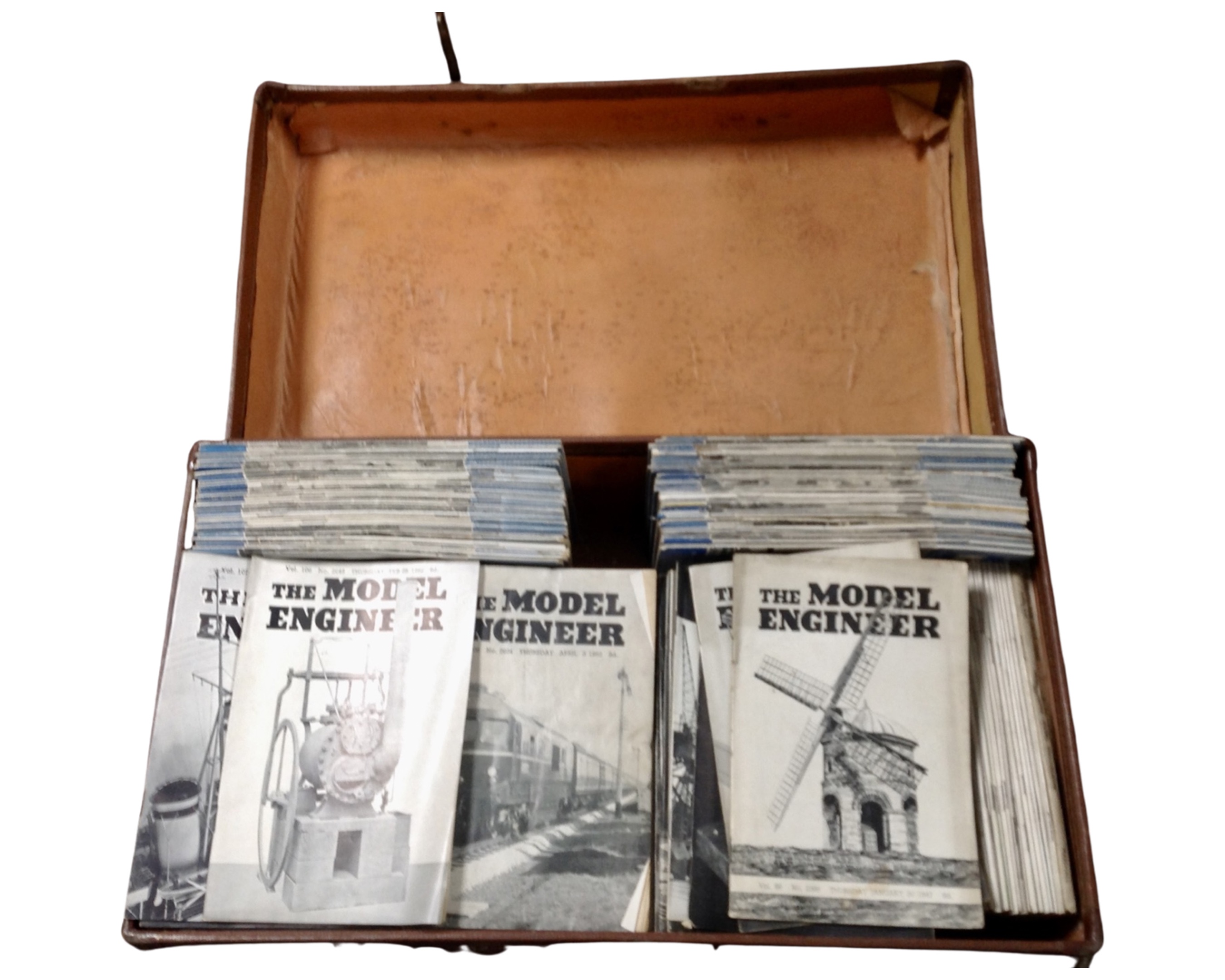 A vintage luggage case containing mid-20th century model engineer magazines.