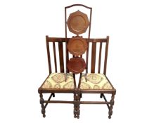 A pair of Edwardian oak dining chairs together with a mahogany three tier folding cake stand.
