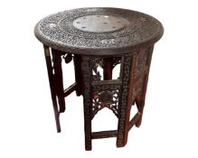 A carved Indian hardwood occasional table.
