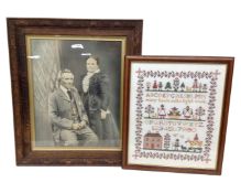 An Edwardian photograph of a lady and a gentleman, in carved oak frame,