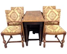 A 20th century oak gateleg table together with a set of four oak dining chairs upholstered in a