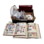 A box containing stamp albums and a large quantity of loose antique and later world stamps.