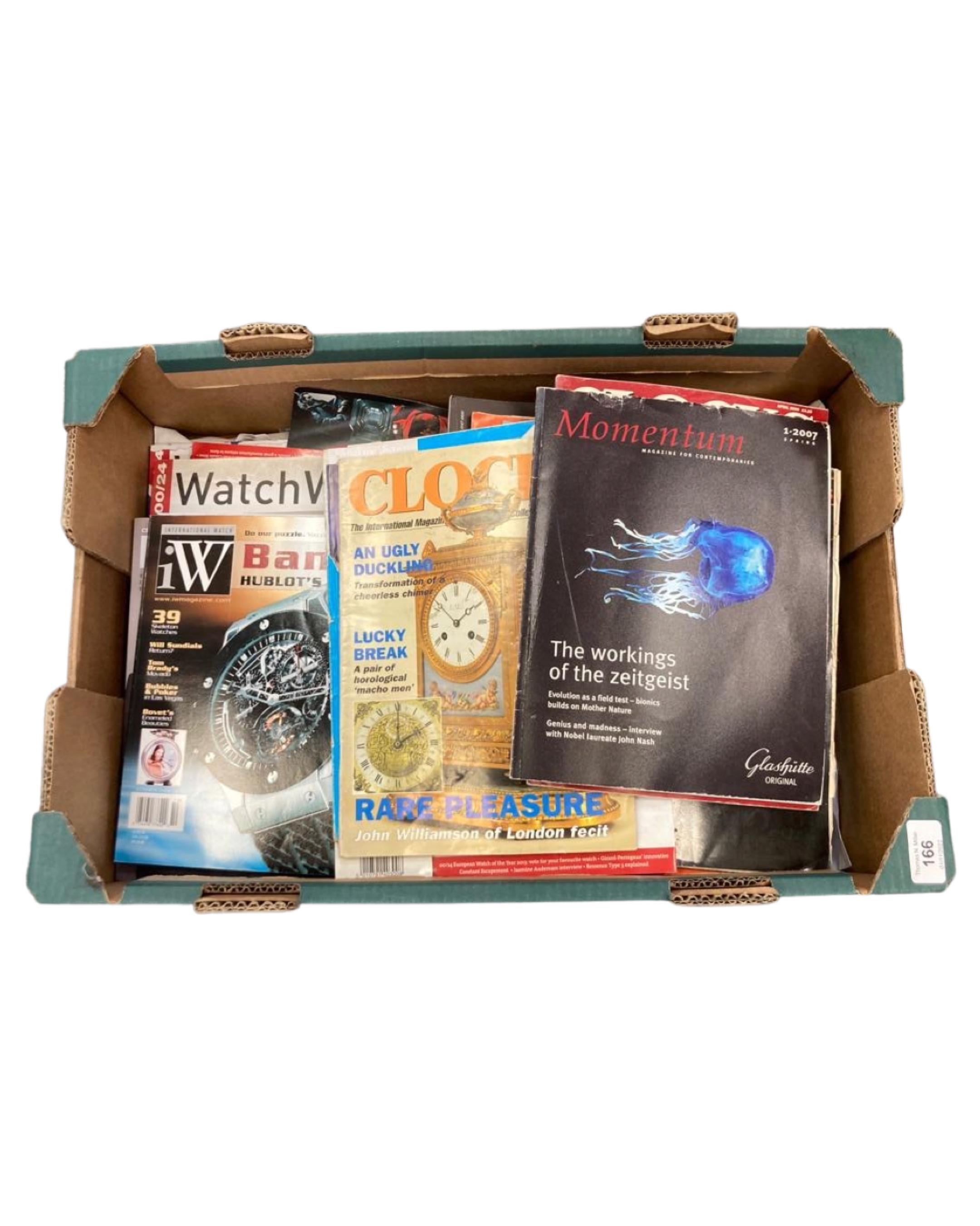 A box containing a large quantity of books relating to antiques, watches,